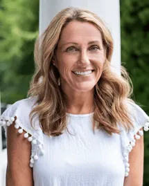charlotte-drug-treatment-centers-amy-catchpole-intake-specialist Amy McDonnell, a clinical case coordinator at a Charlotte drug treatment center, is smiling in a white blouse.