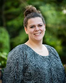 charlotte-drug-treatment-centers-laboratory-scientist-sara-jakab Sara Jakab, Laboratory Scientist at a Charlotte drug treatment center, smiling outdoors in a grey sweater.