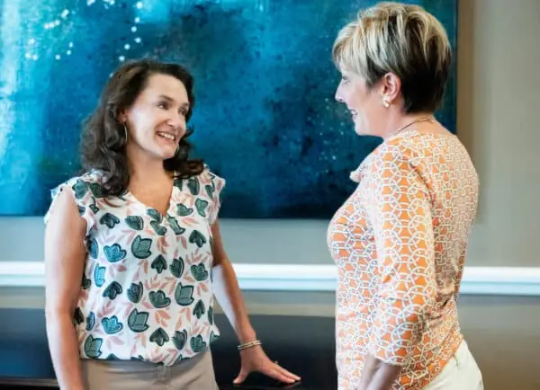 friendly-interaction-charlotte-treatment-center Two women engaging in a friendly conversation at a Charlotte treatment center.