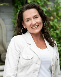 outpatient-alcohol-treatment-patient-accounts-representative-corinne-freer Corinne Freer, Patient Accounts Representative for outpatient alcohol treatment, in a white jacket.