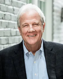 Charles Odell, CEO and President of an outpatient rehab center in Charlotte, NC, smiling in a blazer.