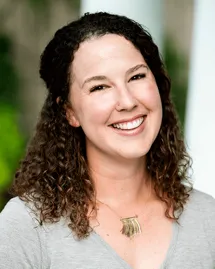 outpatient-rehab-charlotte-nc-counselor-jordan-tadlock Jordan Tadlock, Licensed Marriage and Family Therapist and Counselor at an outpatient rehab in Charlotte, NC, smiling in a grey top.