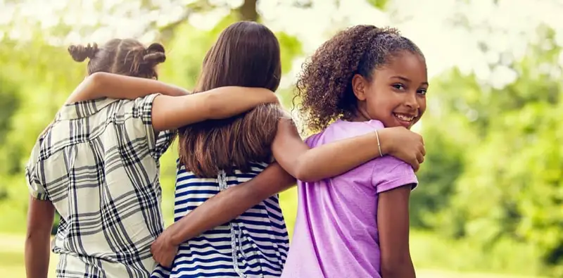 Three children embracing, representing the supportive community in addiction recovery programs at Dilworth Center in Charlotte, NC.